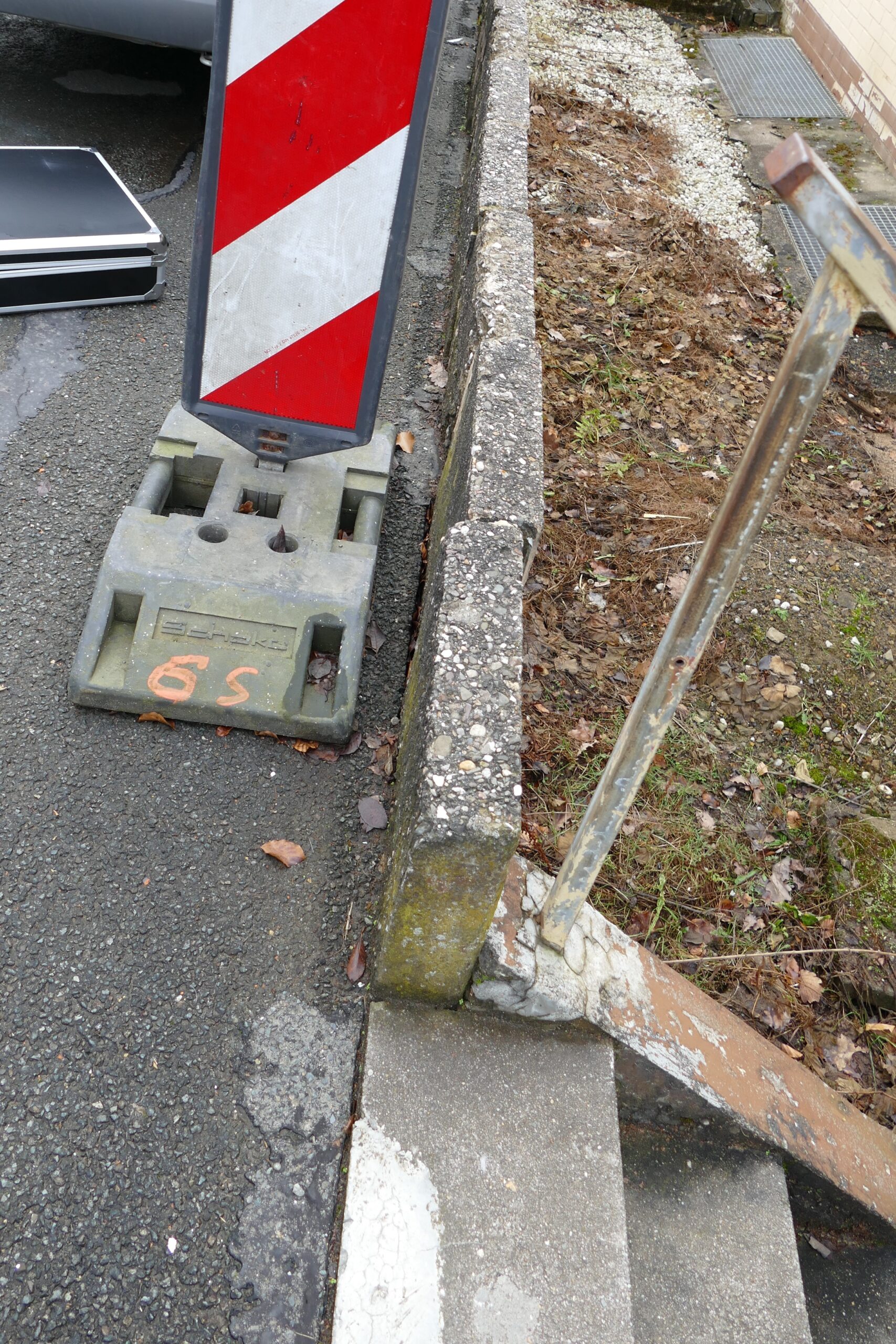 Bauschadengutachten bei einer beschädigten und verschobenen Stützmauer im Außenbereich.
